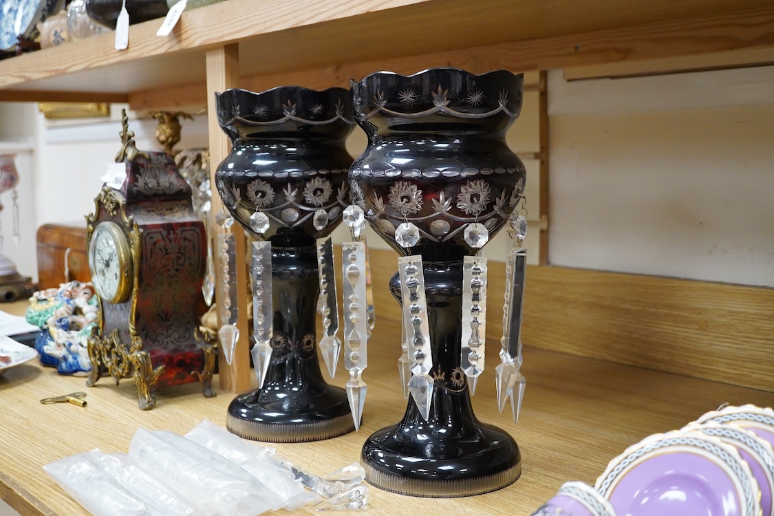 A pair of 19th/20th century deep ruby flashed cut glass lustres, 36cm high
